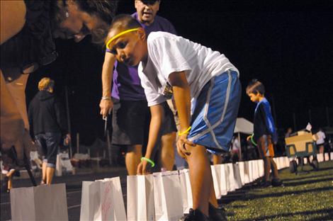 A luminaria honors Florence Kneebone, one of more than 500 lit bags circling the track at Ronan High School on Friday for Lake County’s Relay for Life event.