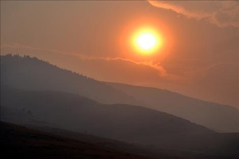 Friday’s sun is obscured by smoke. 
