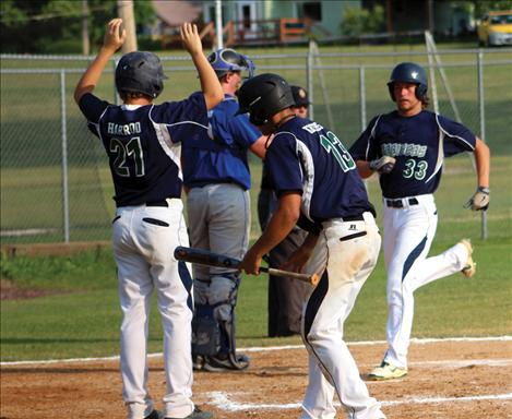 Mariner Jared Young crosses home plate to score