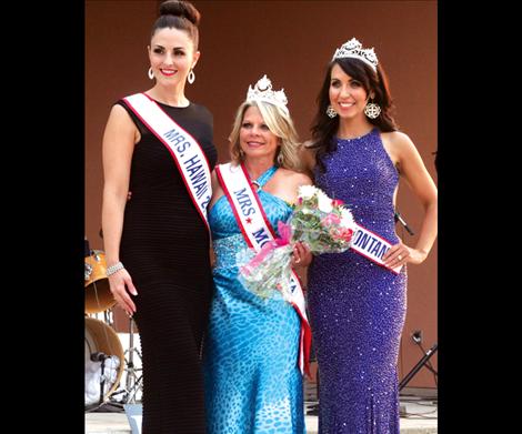 Mrs. Hawaii 2013 Jaci Agustin, left, and Mrs. Montana Alyssa Schrock, right, crown Cindy Archer Mrs. Montana 2014 Friday night at the St. Ignatius amphitheater.