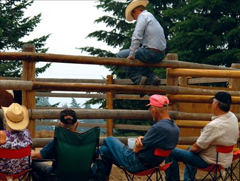 Clinic participants Erlene Robinson, left, Robert Robinson, Mark Scott and Scott Branson watch as Barb Reber works with her horse.