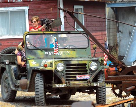 H. J. Pieper drives an Army jeep loaded with guests around the grounds at the Miracle of America Museum.