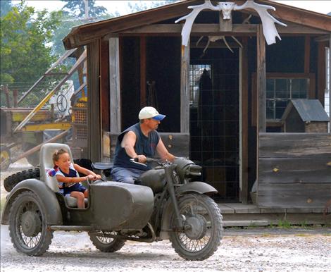 Rylee Buckless, 5, grins as she careens around a corner in a sidecar.