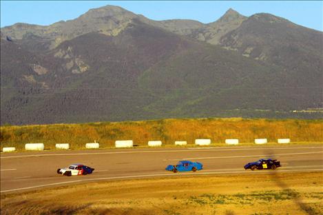 A group of enduro cars hit the corner on their way to the finish line at the Missison Valley Speedway
