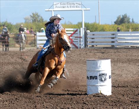 Kara Clinkenbeard from Arlee heads towards the final barrel at the Polson High School rodeo held at the Polson Fairgrounds.