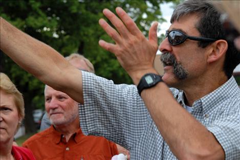 Mark Fenton points at an intersection as he conducts a walking audit in Whitefish with a group of people interesting in making their communities more walker, biker and transit friendly. 