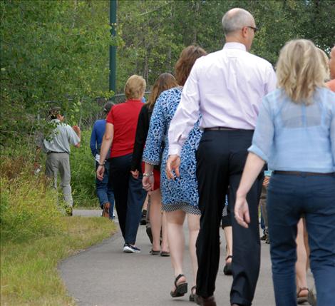 Workshop participants walk through areas of Whitefish.