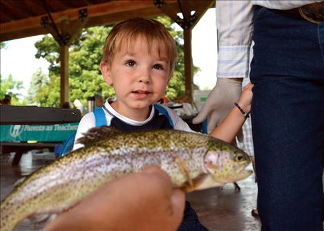 Manny Barber doesn't want to touch the fish he caught during the Fishing Derby.