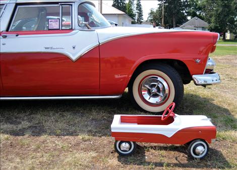 A vintage toy Crown Victoria is dwarfed by the real 1955 gem