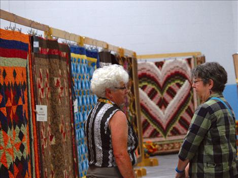 Peggy Olson, left, visits with a friend at the Mission Valley Quilt Guild Quilt Show.