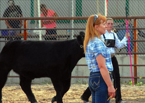 Virginia Kneer checks Laurel Rigby's calf.