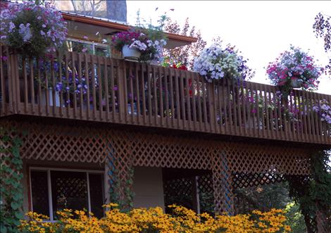 Flowering plants on the deck, flowerbeds, and lots of ornamental trees grow all over Bertsch’s property on Memory Lane.