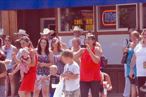 A crowd of people enjoy watching the Lake County Fair parade on Main Street.