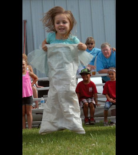 Catching some air during the sack race at the fair.