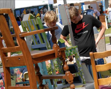 Bidders check their item  as Life Savers Animal  Rescue holds the final day  of their silent  auction at the  Sandpiper Art  Festival. 