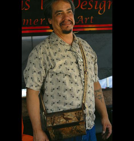 ion Alberts wears a traditional berry basket he made, mostly from birch bark.