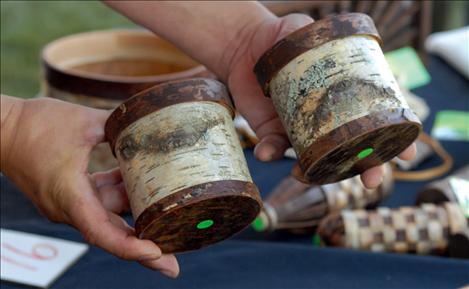 Dion Albert gets to know his birch bark creations including two he calls Mr. Happy and Mr. Sad.