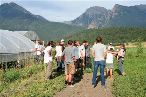 ulie Pavlock, right, explains  her farming techniques  to a group of  interested folks.