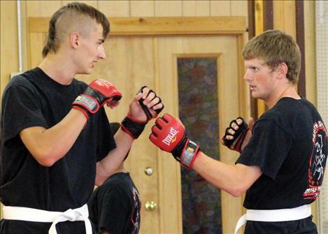 Gibson Brooks and Mitchell Gaukel spar during the Mixed Martial Arts class.