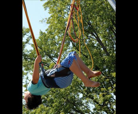 A young lad swings on a bungee cord during Summerfest in Polson.