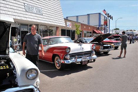 Spectators peruse vintage cars Saturday along Polson’s Main Street.