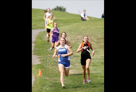 Lady Bulldog Courtney Heath leads a downhill charge during the Ronan Invitational cross-country meet.
