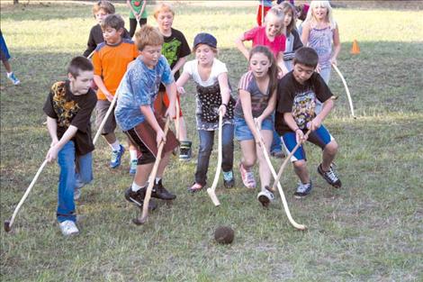 Stevensville fourth-grade students play stickball on the Peoples’ Center grounds