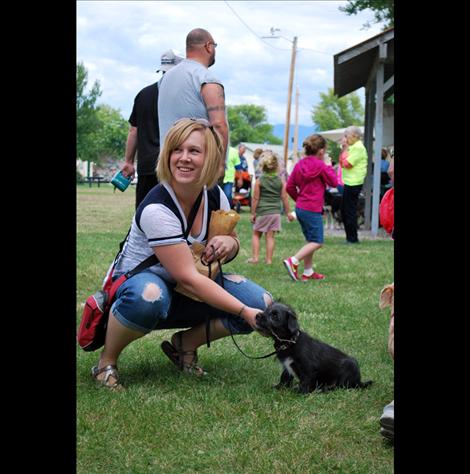 Kendra Becker pets Buck, her newly adopted puppy from Mission Valley Animal Shelter.