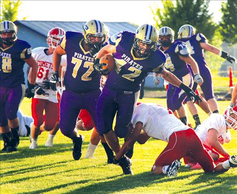 Polson Pirate Joe Gallatin dodges defenders in a game against the Raymond, Alberta Comets. 