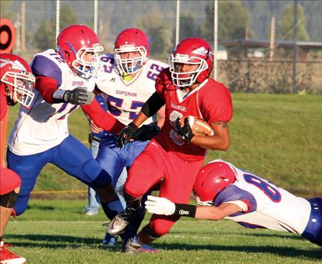 Arlee Warrior PJ Haynes carries the ball during Friday night’s football game against the Superior Bobcats.