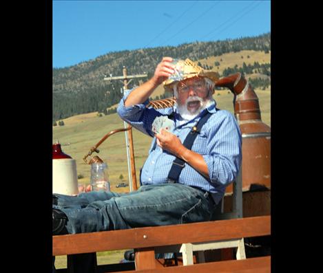 A card-playing, moonshine-drinking man rides in the Dayton Days parade, where this year’s theme is Gangsters, Molls and the Roaring Twenties.