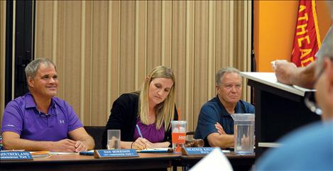 Polson City Commissioner Dan Morrison, left, Mayor Heather Knutson, and Commissioner John Campbell listen as a community  member speaks. 