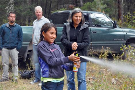 Alishon Kelly deploys bear spray. 