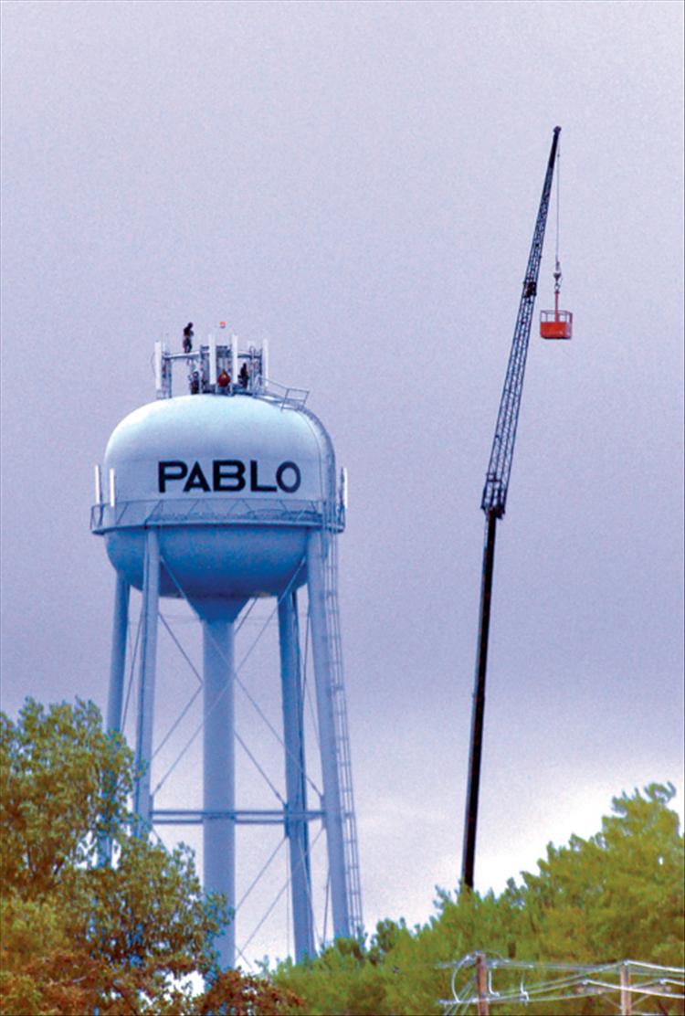 A new AT&T cell phone tower is installed atop the 300 foot tall Pablo water tower.