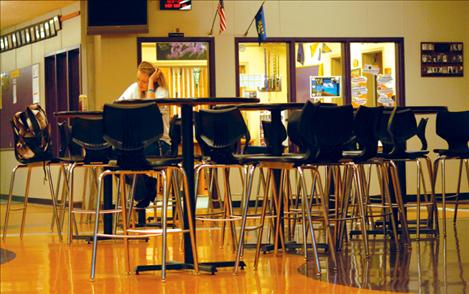 Shilah Doble, a PHS senior, utilizes the new tables and stools in the high school lobby. Doble was in a leadership class last year and helped choose the new furniture.