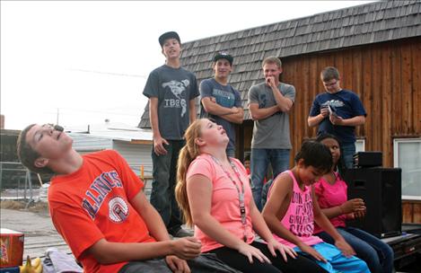 Kids try to get a cookie from their foreheads to their mouths without using their hands. 