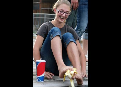 Monique Smith, 14, peels a banana with her feet. 