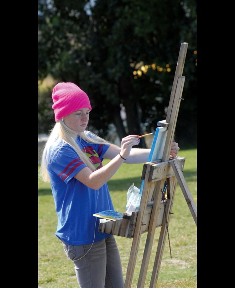 Breanna Bilile paints in Riverside Park during the plein air Worldwide Paintout on Sept. 13. About 10 artists dispersed around the Mission Valley to enjoy painting in the great outdoors.