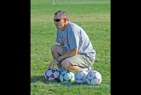 Polson girls’ head coach Michael Hewston keeps an eye on his Lady Pirates during practice last week.