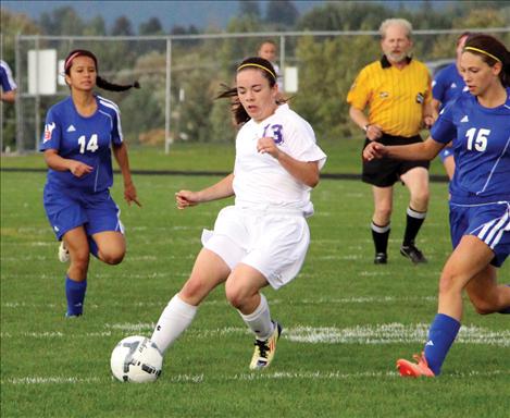 Two-time All-State recipient Sarah Howell craftily sneaks by opponents at Thursday’s Homecoming game against Bigfork.