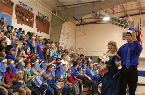 Homecoming Queen Courtney Heath and King Raymond Matt walk the gym after being crowned.