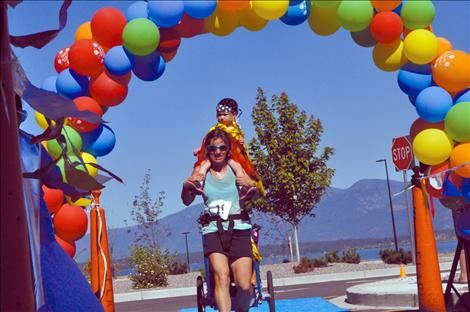 Megan Strickland/Valley Journal Lauren Arnold and Marguerite Brenner cross the finish line at the Mission Valley Kids Walk Run 5K. 