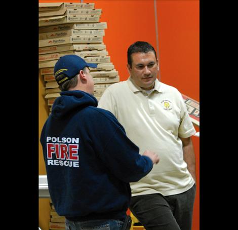 Linderman dad Robert DePoe, right, talks with a friend by a stack of 57 empty pizza boxes at the kick-off for WATCH D.O.G.S. at Linderman School.