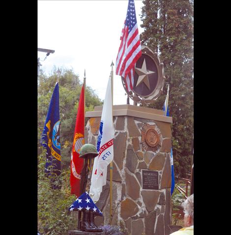 A battle cross and flags adorn the Gold Star Mothers Memorial in Bockman Park. 