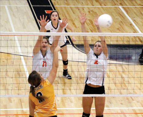 Maiden Sydnee Clairmont slams over a kill while teammate Kendra Starkel provides backup.