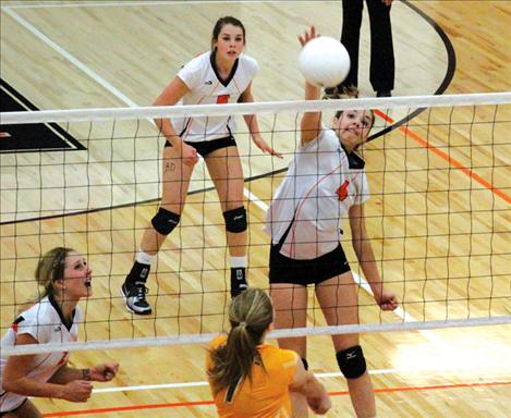 Ashley Peterson and McKenzie Dulmes jump for a block.