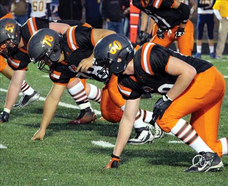 Chiefs Cole Gerhardt, Michael Irvine and Andrew Clary set up a defensive wall against Deer Lodge at Friday’s Homecoming game.