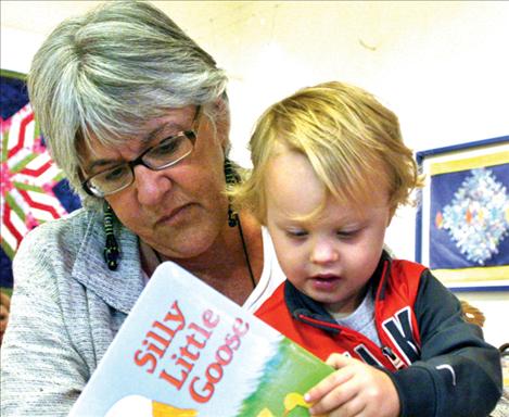 Karen Peterson photo Family support specialist Jen Blumberg from Lake County Public Health reading to two-year-old Braxtyn Chadwick.