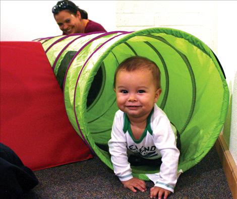 Renata Lindo watches her 10-month-old son Jaques play with toys provided by Parents as Teachers.