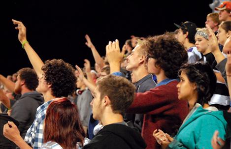 Students in the stands sing along with the Catalyst Youth Band to “Stand with Arms High and Heart Abandoned.”